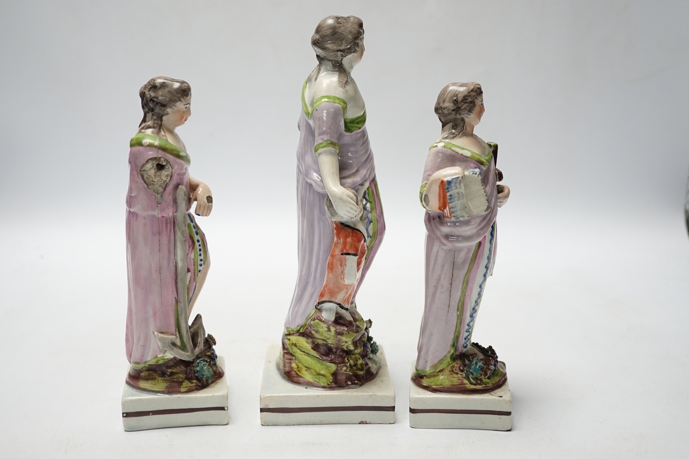 A set of three pearlware figures of Faith, Hope and Charity, c.1810, largest 21cm high